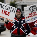 Jim Hanks from Lexington, S.C., wears the Confederate flag as he protests against Republican presidential hopeful Sen. John McCain, R-Ariz., outside a campaign event in Columbia, S.C., Thursday, Jan. 17, 2008. (AP Photo/Charles Dharapak)
