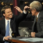 In this photo released by CBS, Democratic Presidential candidate John Edwards, left, reaches for host David Letterman's head after having his hair messed up by Letterman on the set of "The Late Show with David Letterman," Tuesday, Jan. 22, 2008, in New York. (AP Photo/CBS, J.P. Filo)