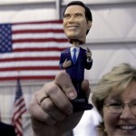Karen Zmoos holds up a Romney bobble-head doll during a campaign stop for Republican presidential hopeful former Massachusetts Gov. Mitt Romney at the Orlando-Sanford International airport in Sanford, Fla., Monday, Jan. 28, 2008. (AP Photo/LM Otero)