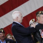 Republican presidential hopeful, Sen. John McCain, R-Ariz., signs an autograph for an unidentified veteran at a campaign event in Orlando, Fla., Monday, Jan. 28, 2008. (AP Photo/Charles Dharapak)
