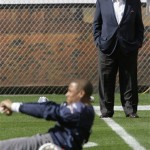 New England Patriots owner Robert Kraft, back right, watches as Patriots safety Rodney Harrison stretches before football practice begins at Sun Devil Stadium in Tempe, Ariz., Monday, Jan. 28, 2008. The Patriots will play the New York Giants in Super Bowl XLII in Glendale, Ariz., on Feb. 3. (AP Photo/Stephan Savoia)