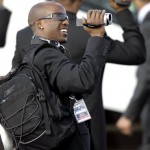 New York Giants cornerback Kevin Dockery videotapes his teammates as they arrive Monday, Jan. 28, 2008, at Sky Harbor International Airport in Phoenix. The Giants will face the New England Patriots in NFL football's Super Bowl XLII in Glendale, Ariz., on Sunday. (AP Photo/Matt York)