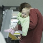A father holds his child as he marks his ballot in the Florida primary, Tuesday, Jan. 29, 2008, in Tallahassee, Fla. (AP Photo/Phil Coale)