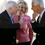 Republican presidential hopeful Sen. John McCain, R-Ariz., left, talks with Florida Gov. Charlie Crist as McCain's wife Cindy, center, looks on, during a visit to a polling station in St. Petersburg, Fla., Tuesday, Jan. 29, 2008, on the morning of Florida's Republican Presidential Primary. (AP Photo/Charles Dharapak)