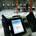 A touch screen voting machine sits idle as voters cast their paper ballot votes in the Florida primary, Tuesday, Jan. 29, 2008, in Tallahassee, Fla. (AP Photo/Phil Coale)