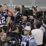 New England Patriots quarterback Tom Brady is surrounded as he answers questions during media day for the Super Bowl XLII football game Tuesday, Jan. 29, 2008, in Glendale, Ariz,. (AP Photo/Stephan Savoia)