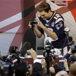 New England Patriots quarterback Tom Brady takes pictures during media day for the Super Bowl XLII football game Tuesday, Jan. 29, 2008, in Glendale, Ariz,. (AP Photo/Stephan Savoia)
