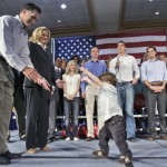 During a Florida primary day campaign rally grandson Parker Romney, front right, runs to Republican presidential hopeful former Massachusetts Gov. Mitt Romney, left, as Romney family members look on in Tampa, Fla., Tuesday, Jan. 29, 2008. From left, Romney, his wife Ann, daughter-in-law Andelyne, sons Ben, Josh, Craig and daughter-in-law Mary. (AP Photo/LM Otero)
