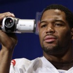 New York Giants defensive end Michael Strahan video tapes member of the media before answering questions during a media availability, Wednesday, Jan. 30, 2008 in Chandler, Ariz. The Giants play the New England Patriots in Super Bowl XLII on Sunday, Feb. 3 in Glendale, Ariz. (AP Photo/Julie Jacobson)