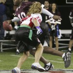 Former NFL football player and team Americanos quarterback Kordell Stewart looks to pass as team Nacionales' Aylin Mujica pursues during the Tazon Latino II football game at the NFL Experience on Wednesday, Jan 30, 2008 in Glendale, Ariz. (AP Photo/Matt York)