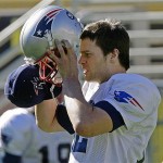 New England Patriots quarterback Tom Brady (12) takes off his hat and puts on his helmet as practice begins at Sun Devil Stadium on the Arizona State University campus in Tempe, Ariz., Thursday. The Patriots will play the New York Giants in Super Bowl XLII in Glendale, Ariz., Sunday.