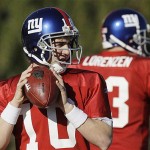 New York Giants quarterback Eli Manning, left, steps back to pass while taking snaps with Jared Lorenzen during practice Thursday, in Tempe, Ariz. The Giants will play the New England Patriots in the Super Bowl on Sunday.