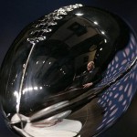 New York Giants head Coach Tom Coughlin is reflected in the Vince Lombardi Trophy at a news conference at the Phoenix Convention Center Friday, Feb. 1, 2008, in Phoenix. The New England Patriots play the New York Giants in Super Bowl XLII on Sunday, Feb. 3. (AP Photo/Eric Gay)