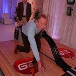 NFL great Archie Manning bowls for charity while son and Indianapolis Colts quarterback Peyton Manning looks on inside the G2 Lounge, a hot spot at the Media Center at Super Bowl XLII in Phoenix showcasing G2, a new low- calorie drink for athletes off the field. (PRNewsFoto/Gatorade)