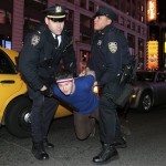 A man is arrested for jumping onto a taxi while celebrating the New York Giants' Super Bowl XLII victory in Times Square on Sunday, Feb. 3, 2008 in New York. (AP Photo/Gary He)
