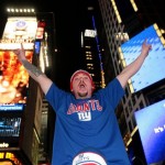 John Bowden celebrates the New York Giants' Super Bowl XLII victory in Times Square on Sunday, Feb. 3, 2008 in New York. (AP Photo/Gary He)