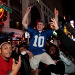 Zack Boisvert, center, and others celebrate the New York Giants Super Bowl XLII victory in Times Square Sunday, Feb. 3, 2008 in New York. (AP Photo/Gary He)
