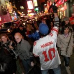 Jason Jagtal, in an Eli Manning uniform, celebrates the New York Giants' Super Bowl XLII victory in Times Square Sunday, Feb. 3, 2008 in New York. (AP Photo/Gary He)