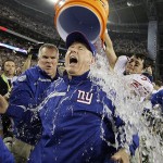 New York Giants head coach Tom Coughlin is doused by his player Madison Hedgecock after the Giants beat the New England Patriots 17-14 in the Super Bowl XLII football game on Sunday, Feb. 3, 2008, in Glendale, Ariz. (AP Photo/David J. Phillip)