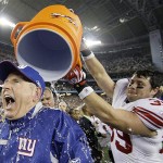 New York Giants head coach Tom Coughlin is doused by his player Madison Hedgecock after the Giants beat the New England Patriots 17-14 in the Super Bowl XLII football game on Sunday, Feb. 3, 2008, in Glendale, Ariz.(AP Photo/David J. Phillip)
