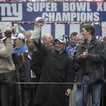 New York City Mayor Michael Bloomberg, center, holds the Vince Lombardi Trophy, as New York Giants players Michael Strahan, left, and Eli Manning and coach Tom Coughlin, behind Bloomberg, celebrate during a Super Bowl parade in New York on Tuesday, Feb. 5, 2008. The Giants defeated the New England Patriots, 17-14, in Sunday's National Football League championship game. (AP Photo/Mike Groll)
