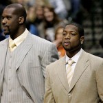 Miami Heat's Shaquille O'Neal, left, and Dwyane Wade, right, look on during warm-ups prior to a NBA basketball game against the Dallas Mavericks in Dallas, Friday, Jan. 4, 2008. Neither of the players participated in the game, Wade due to an accumulation of injuries, including his right pinkie and right shoulder, and O'Neal was out due to bursitis in his left hip. (AP Photo/Tony Gutierrez)
