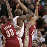 Miami Heat center Shaquille O'Neal, center, is fouled by Cleveland Cavaliers center Anderson Varejao of Brazil, right, in the second quarter during a basketball game in Miami, on Monday, Jan. 21, 2008. At left is Cavaliers forward Devin Brown. (AP Photo/Lynne Sladky)
