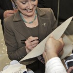 Democratic presidential hopeful Sen. Hillary Rodham Clinton, D-N.Y., signs a cowboys hat after speaking at a campaign stop at the Don Haskin Arena in El Paso, Texas, Tuesday, Feb. 12, 2008. (AP Photo/LM Otero)
