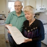  Ben Kreisher and his wife Pati pose for a photograph as they display documents from the closing of their mortgage at their home in East Goshen, Pa., Thursday, Dec. 20, 2007. The Kreishers, who now fear losing their home of 35 years, say key details of their mortgage _ such as the fact that their principal balance could actually increase over time _ were obscured when a local mortgage broker came to their home in April 2006 with papers to sign. (AP Photo/Matt Rourke)
