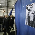  A photo of a young John McCain as a Navy pilot hangs on a curtain as the Republican presidential hopeful, Sen. John McCain, 