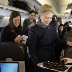 Democratic presidential hopeful, Sen. Hillary Rodham Clinton, D-N.Y., passes out Valentine's day chocolates to the traveling press aboard her campaign plane as it sat on the tarmac at the Youngstown Airport in Vienna, Ohio, Thursday, Feb. 14, 2008. (AP Photo/Carolyn Kaster)