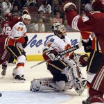 Calgary Flames goaltender Miikka Kiprusoff, center, of Finland, reacts as the pucks bounces back out of the net on a goal by Phoenix Coyotes Derek Morris, not shown, during the second period of an NHL hockey game, Tuesday, Feb. 19, 2008, in Glendale, Ariz.(AP Photo/Roy Dabner)