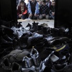 A pile of footwear is seen in front of Kosovar Albanians while they pray on the yard of the mosque of the ethnically divided town of Kosovska Mitrovica, Kosovo, Friday, Feb. 22, 2008. Kosovo's predominantly Albanian leadership proclaimed independence from Serbia with western backing on Sunday. (AP Photo/Bela Szandelszky)
