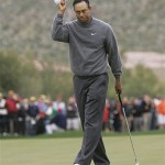 Tiger Woods tips his hat to the crowd after he defeats opponent Aaron Baddeley in their match, 1 up in 20 holes, during the third round of the Accenture Match Play Championship golf tournament at The Gallery Golf Club at Dove Mountain, in Marana, Ariz., Friday.