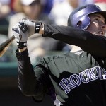 Colorado Rockies' Brad Hawpe hits a three run home run during the first inning of a spring training baseball game against the Arizona Diamondbacks Monday, in Tucson, Ariz. The Rockies defeated the Diamondbacks 7-5.