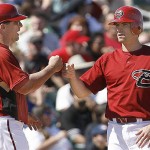 Arizona Diamondbacks' Chris Burke, right, celebrates with third base coach Chip Hale after hitting a double against the Seattle Mariners during the fourth inning of a spring training baseball game on Sunday, March 9, 2008, in Tucson, Ariz. (AP Photo/Nam Y. Huh)
