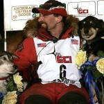 Lance Mackey sits with two of his dogs, Larry, left, and Handsome after winning the Iditarod Trail Sled Dog Race in Nome, Alaska early Wednesday March 12, 2008. (AP Photo/Al Grillo)