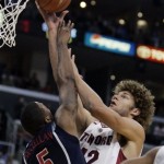 Stanford center Robin Lopez (42) shoots over the defense of Arizona guard Jawann McClellan (5) in the first half of a quarterfinal game in the Pac-10 men's basketball tournament at Staples Center in Los Angeles Thursday, March 13, 2008. (AP Photo/Reed Saxon)