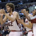 Stanford's Robin Lopez, left, cheers for his teammates from the bench against Arizona during the second half of their quarterfinals basketball game at the Pac-10 men's college basketball tournament at the Staples Center in Los Angeles Thursday, March 13, 2008. Lopez finished with 14 points and Stanford defeated Arizona, 75-64. (AP Photo/Kevork Djansezian)