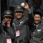 Chinese security guards stationed behind leftfield at Wukesong Baseball Field show off home run balls they retrieved as they were hit over the fence during the San Diego Padres' batting practice before an exhibition game against the Los Angeles Dodgers, Sunday, March 16, 2008, in Beijing, China. (AP Photo/Robert F. Bukaty)