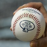 A baseball bearing the MLB-China Series logo is held by a fan before an exhibition game between the Los Angeles Dodgers and the San Diego Padres, Sunday, March 16, 2008, in Beijing, China. (AP Photo/Robert F. Bukaty)
