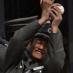 A Chinese security guard catches a baseball he was playing with after it was hit over the leftfield fence at Wukesong Baseball Field during the San Diego Padres' batting practice before an exhibition game against the Los Angeles Dodgers, Sunday, March 16, 2008, in Beijing, China. (AP Photo/Robert F. Bukaty)