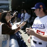 Los Angeles Dodgers pitcher Justin Germano, right, speaks to a Chinese reporter before an exhibition game against the San Diego Padres, Saturday, March 15, 2008, in Beijing, China. (AP Photo/Robert F. Bukaty