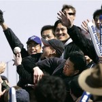 Chinese baseball fans reach for a ball during an exhibition game between Los Angeles Dodgers and San Diego Padres, Saturday, March 15, 2008, in Beijing, China. (AP Photo/Robert F. Bukaty)
