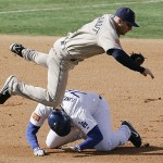 San Diego Padres third baseman Kevin Kouzmanoff jumps over Los Angeles Dodgers' John Lindsey after tagging Lindsey out in a run-down during an exhibition baseball game, Saturday, March 15, 2008, in Beijing, China. (AP Photo/Robert F. Bukaty)
