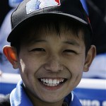 A young Chinese baseball fan attends an exhibition game between the Los Angeles Dodgers and San Diego Padres, Saturday, March 15, 2008, in Beijing, China. (AP Photo/Robert F. Bukaty)