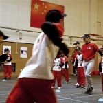 San Diego Padres' Andy School teaches Chinese students exercise at a youth clinic in Beijing, China, Friday, March 14, 2008. The Los Angeles Dodgers will play the San Diego Padres on Saturday and Sunday. Wukesong Baseball Field will be used for the 2008 Beijing Olympics. (AP Photo/Andy Wong)
