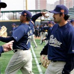 San Diego Padres first basemen Adrian Gonzalez, right, and team manager Bud Black, left, look while team players warms up during a training session at Wukesong Baseball Stadium in Beijing, China, Friday, March 14, 2008. The Los Angeles Dodgers will play the San Diego Padres on Saturday and Sunday. Wukesong Baseball Field will be used for the 2008 Beijing Olympics. (AP Photo/Andy Wong)