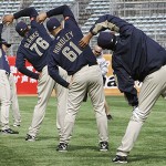 San Diego Padres' baseball team players stretch before a training session at Wukesong Baseball Stadium in Beijing, China, Friday, March 14, 2008. The Los Angeles Dodgers will play the San Diego Padres on Saturday and Sunday. Wukesong Baseball Field will be used for the 2008 Beijing Olympics. (AP Photo/Andy Wong)