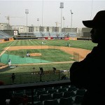A player on the Chinese National Team watches the Los Angeles Dodgers workout, Friday, March 14, 2008, in Beijing, China. The Dodgers will play the San Diego Padres in an exhibition series this weekend. (AP Photo/Robert F. Bukaty)